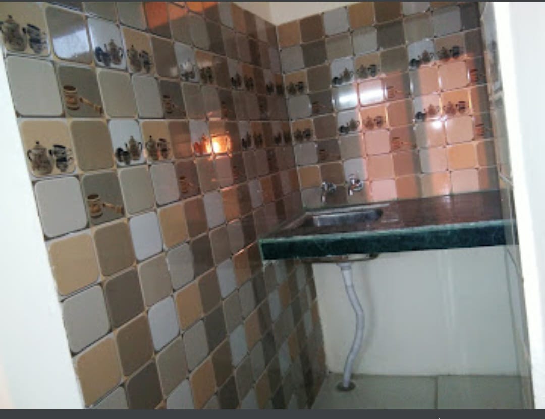 Kitchen facility sink and countertop at Happy International Guest House